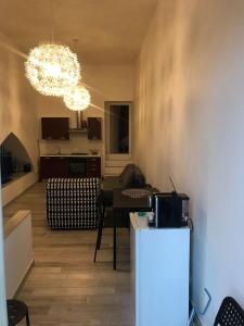 a living room with a chandelier and a table at Il Campanile in Agrigento