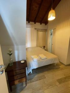 a bedroom with a bed with two towels on it at Il Campanile in Agrigento