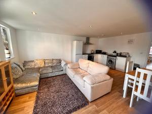 a living room with a couch and a kitchen at Joe Kelly Buildings B in Withernsea