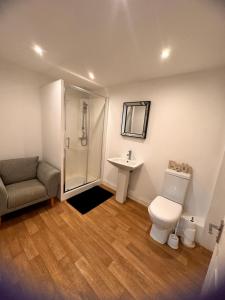 a bathroom with a shower and a toilet and a sink at Joe Kelly Buildings B in Withernsea