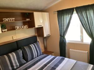 a bedroom with a bed and a window at Holiday Home At Seton Sands in Port Seton