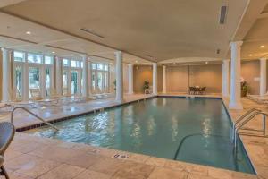 a large swimming pool in a large house at The Beach Club - Doral #701 in Gulf Highlands
