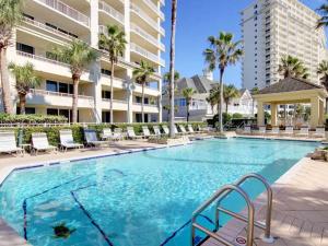 a large swimming pool with chairs and a building at The Beach Club - Doral #701 in Gulf Highlands +38 photos