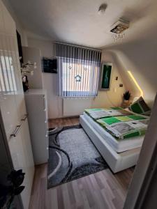 a small bedroom with a bed and a rug at Ferienwohnung galina in Rockenhausen