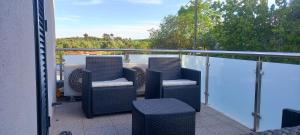 a balcony with wicker chairs on a balcony at Superb Bruzende Village in Baião