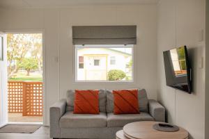a living room with a couch and a window at Taupo TOP 10 Holiday Park in Taupo
