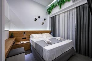 a bedroom with a large bed and a window at Poem in Kos Town