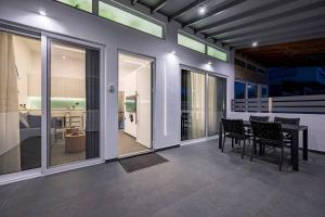 a dining room with a table and chairs at Poem in Kos