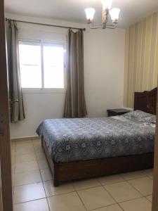 a bedroom with a bed and a window at Ceuta fnideq in Fnidek