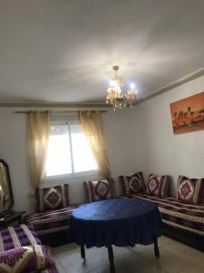 a living room with a couch and a window at Ceuta fnideq in Fnidek