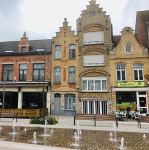 a building with a fountain in front of it at B&B East&West in Ypres
