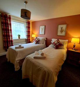 ein Hotelzimmer mit 2 Betten und Handtüchern darauf in der Unterkunft The St Crispin Inn in Worth