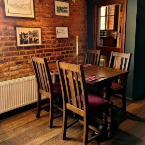 a dining room with a wooden table and chairs at The St Crispin Inn in Worth