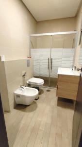 a bathroom with a toilet and a sink at Bridge apartments in Amman