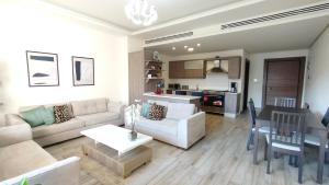 a living room with a couch and a dining room at Bridge apartments in Amman