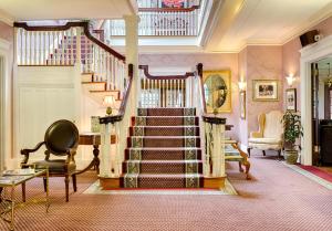 a staircase in a living room with a stair case at Gateways Inn in Lenox