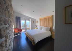 a hotel room with a bed and a window at Casa do Vale de Cerdeiras in Ancede