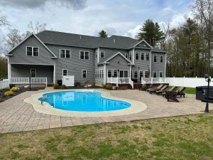 a large house with a swimming pool in the yard at 9 Bedroom Saratoga Retreat, Heated Pool, HotTub, Firepit, Creek, Mini Golf On 10 Acres! in Saratoga Springs