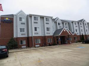 una fila di condomini in un parcheggio di Microtel by Wyndham South Bend Notre Dame University a South Bend