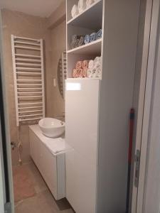 a white bathroom with a sink and a toilet at Lux Apartment Jovanovic in Tivat