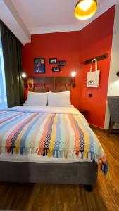 a bedroom with a bed with a red wall at The Abies in Çanakkale