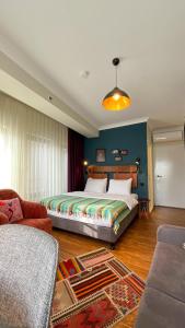 a bedroom with a large bed and a couch at The Abies in Canakkale