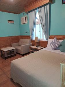 a bedroom with a large bed and a couch at Heart Seed B&B in Kenting