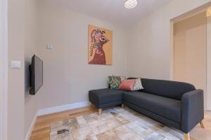 a living room with a couch and a tv at Apartamento reformado en zona residencial con garaje y wifi in Bilbao
