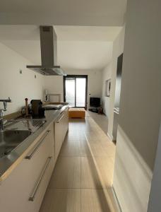 cocina con armarios blancos y suelo de madera en Casa Marì en Ostuni
