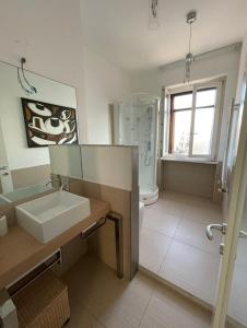 a bathroom with a sink and a toilet and a shower at Casa Marì in Ostuni