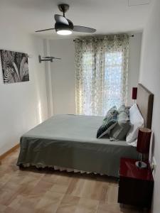a bedroom with a bed and a ceiling fan at UMA luna al sol Benicarlo-Peñiscola in Benicarló +12 photos
