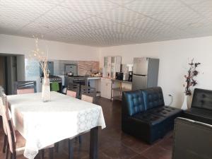 a kitchen and dining room with a table and chairs at Lonko Hostel in Arequipa