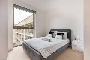 a bedroom with a bed and a large window at Luxury Double bedroom in Gallions Reach in Beckton