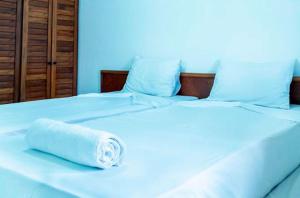 a white towel sitting on top of a bed at Res Village do Bosque 03 in Porto Seguro