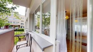 a balcony with a table and chairs and a window at Kotlarska 7 TectumApartments in Wrocław