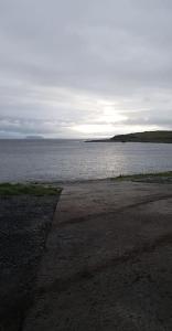 a view of a large body of water with the sun setting at Plumgrove Pod Easkey in Sligo