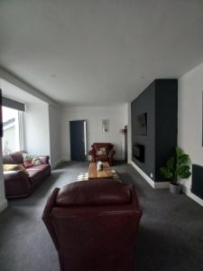 a living room with a couch and a table at NO 27 Apartment in Llandudno