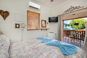 a bedroom with a bed and a view of a porch at Travellers Oasis in Cairns