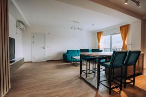 a living room with a table and chairs and a couch at Darki Comfort Apartments - Stylish Apartments with Free Parking in Tranquil Area in Ohrid