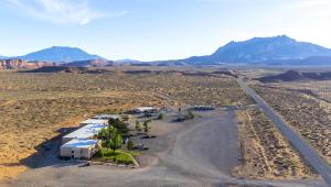 an aerial view of the desert with mountains in the background at Ticaboo Lodge in Ticaboo
