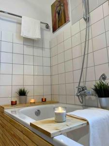 a bathroom with a bath tub with a candle in it at Boho Apartment in der Stadtmitte in Lahr