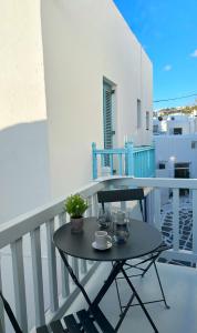 a small black table on the balcony of a house at Oikia Suites Mykonos in Mýkonos City
