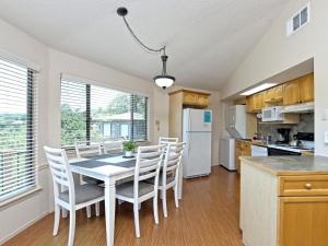a kitchen and dining room with a table and chairs at Lakefront Bungalow With Pool & Hot Tub #10 in Lakeway