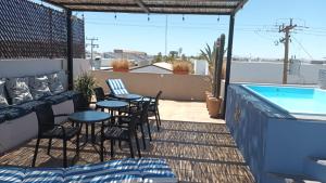 a patio with tables and chairs and a swimming pool at Terraria Apartment 5 in La Paz