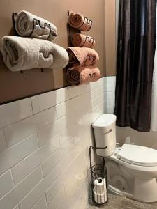 a bathroom with a toilet and a bunch of towels at F.M.T. in Harrisburg