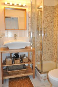 a bathroom with a sink and a shower at Ort Lemkenhafen Ostseeperle in Fehmarn +18 photos