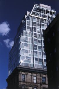 a tall building with glass windows on top of a building at Hotel on Rivington in New York