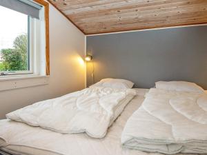two large white beds in a room with a window at Holiday home Haderslev XLV in Haderslev