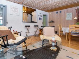 a living room with a glass table and chairs at Holiday home Haderslev XLV in Haderslev
