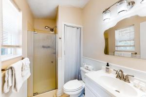 a bathroom with a toilet and a sink and a shower at Happy Pelican in Panama City Beach +7 photos